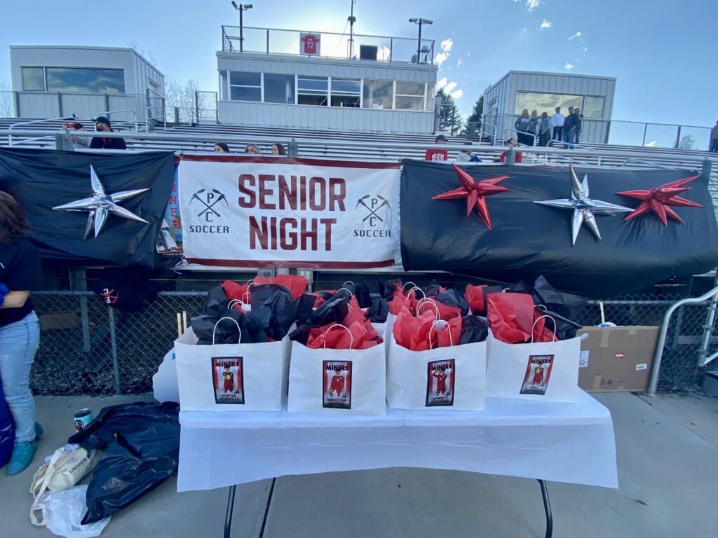 Senior Night signage and swag bags at Dozier Field. 