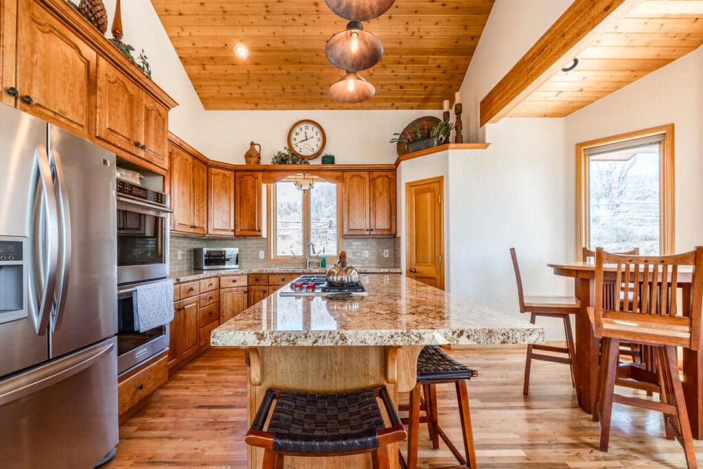 Aspen Lane kitchen with warm woods and granite counters. 