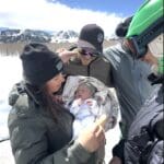 Baby Torin meets friends and neighbors before their snowcat ride home.