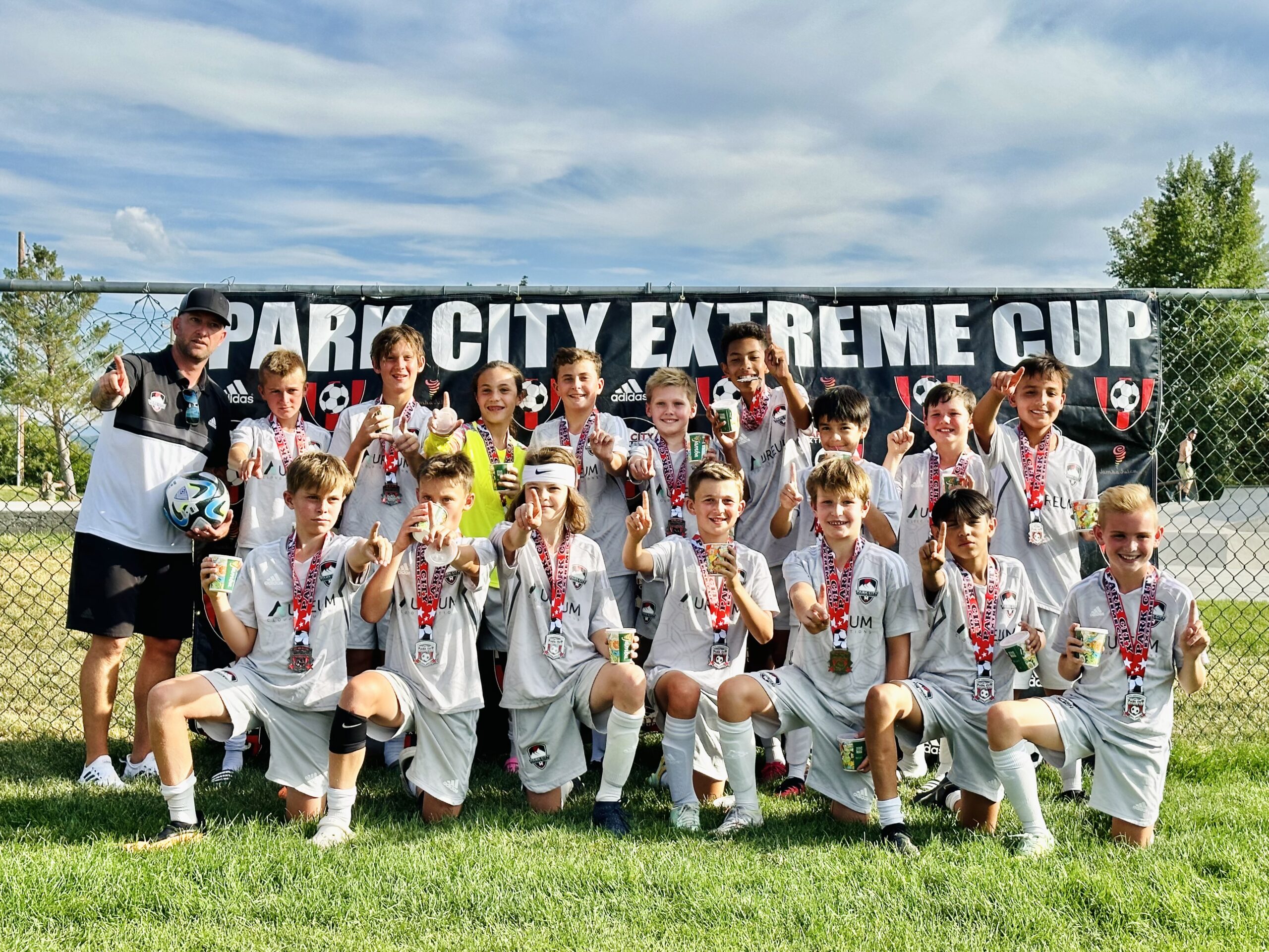 Coach Eli Ulvi with the U13 boys after winning their division in Extreme Cup, July 2023.