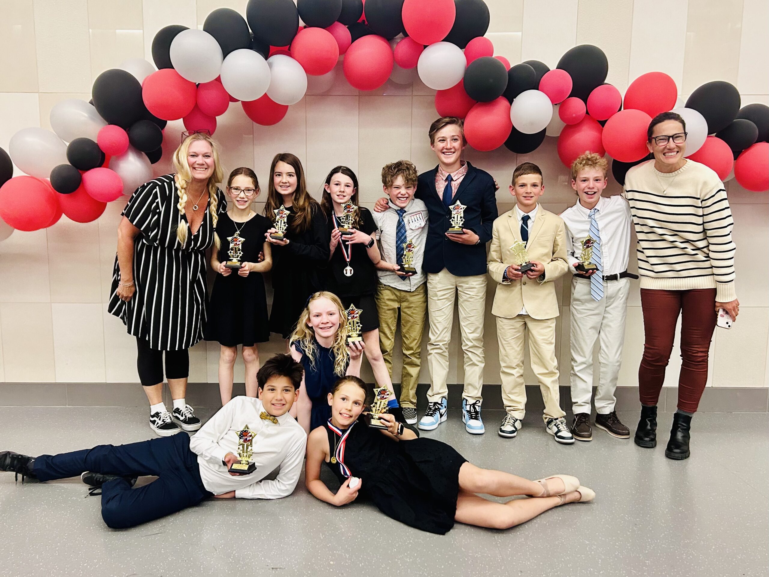 Top row, left to right: Debate coach Melissa Bott, Tess Cartin, Clara Nunnelly, Jenna Shroyer, Lukas Delaney, Ford Kimble, Luke Williamson, Arthur Herrmann, debate coach Katy McCombs. Middle row: Maggie McNeil. Front row: Aramis Turchin and Eva Metzger.