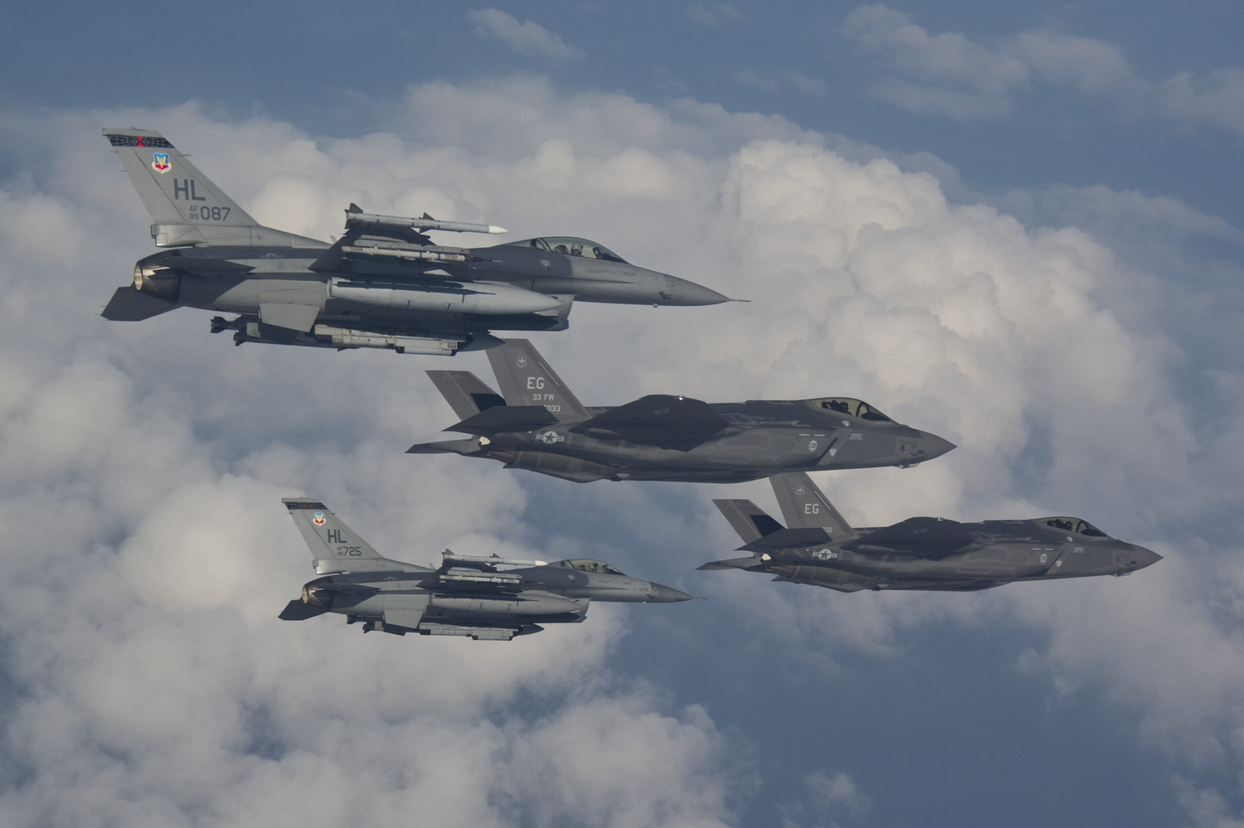 F-16s from Hill Air Force Base fly next to the F-35A Lightning II, the Air Force’s newest fighter jet, in a training mission at Eglin AFB, Fla., Thursday. Hill AFB is slated to receive its first operational F-35s in the fall of 2015.