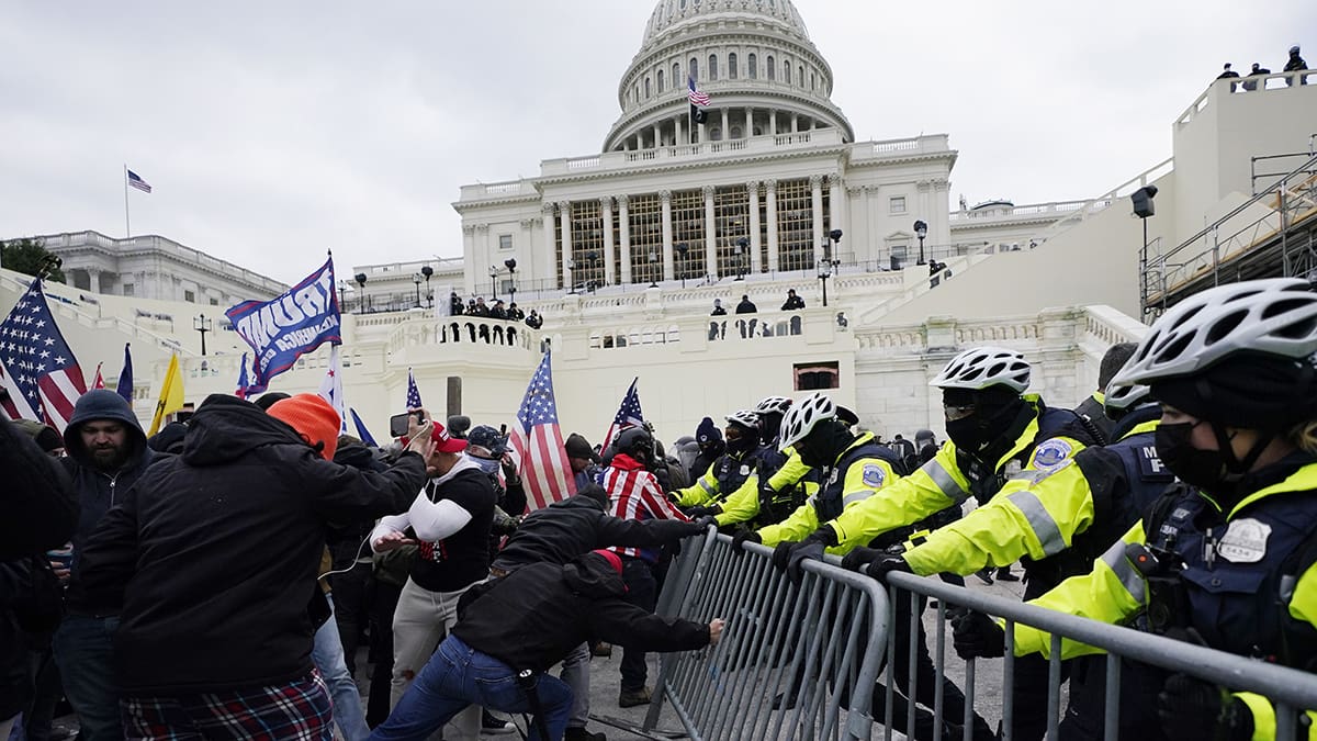 Insurrectionists loyal to President Donald Trump try to break through a police barrier, Wednesday, Jan. 6, 2021, at the Capitol in Washington.