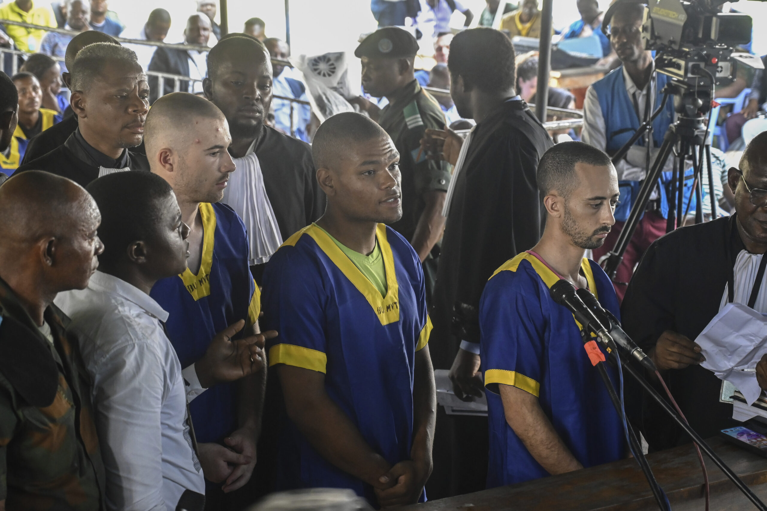 From left T,yler Thompson Jr, Marcel Malanga and Benjamin Reuben Zalman-Polun, all American citizens, face the court in Kinshasa with 52 other defendants Friday June 7, 2024, accused of a role in last month's attempted coup in Congo led by little-known opposition figure Christian Malanga in which six people were killed.