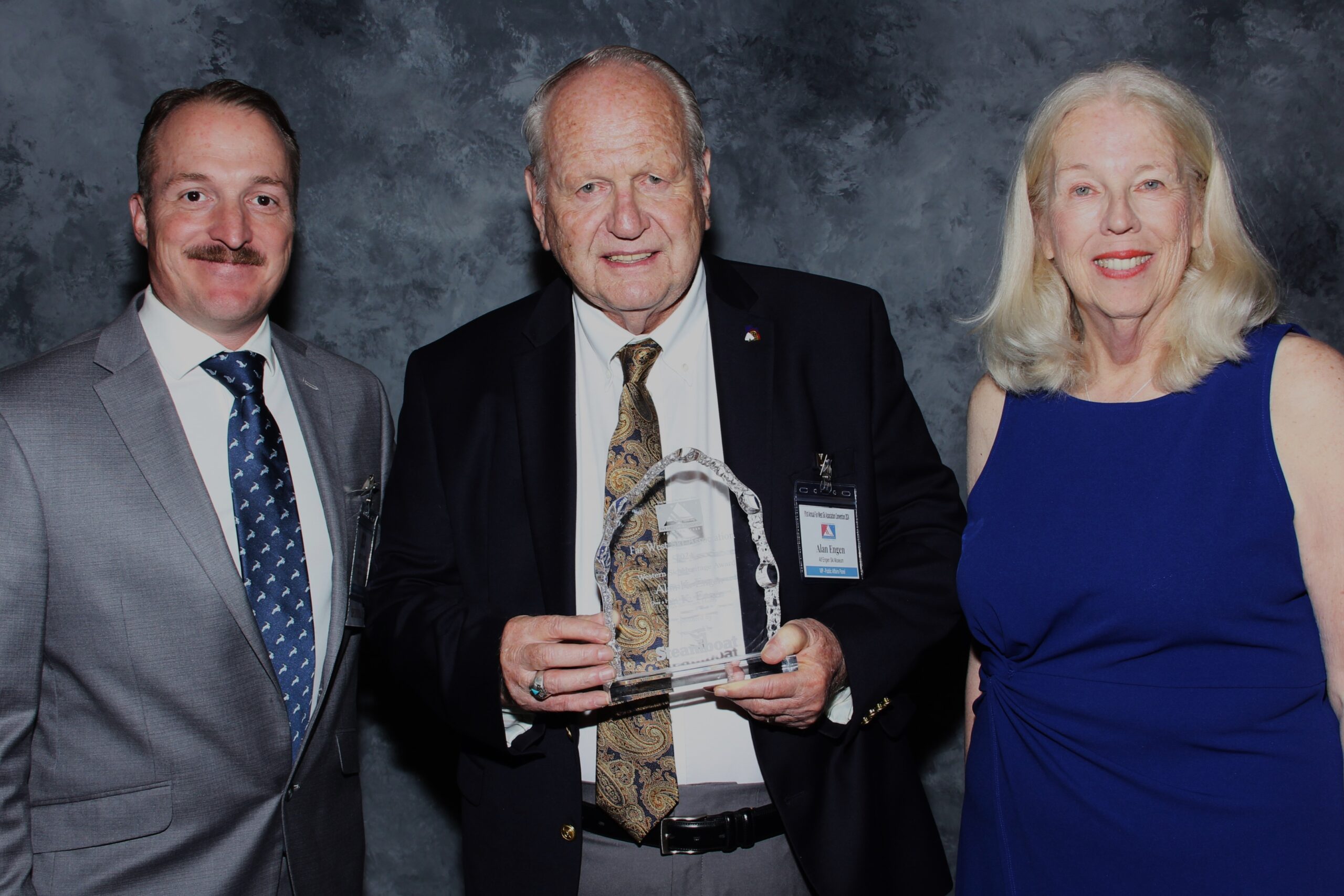 Larry Young, senior sales representative for Steamboat Ski & Resort Corporation, and Jane Wyckoff, history committee chair for the Far West Ski Association, presented Alan K. Engen with the Western Ski Heritage Award at the Awards Banquet at the 91st Annual FWSA Convention.