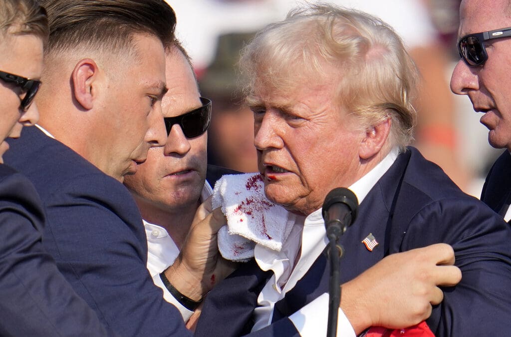 Republican presidential candidate former President Donald Trump is surrounded by U.S. Secret Service at a campaign event in Butler, Pa., on Saturday, July 13, 2024.