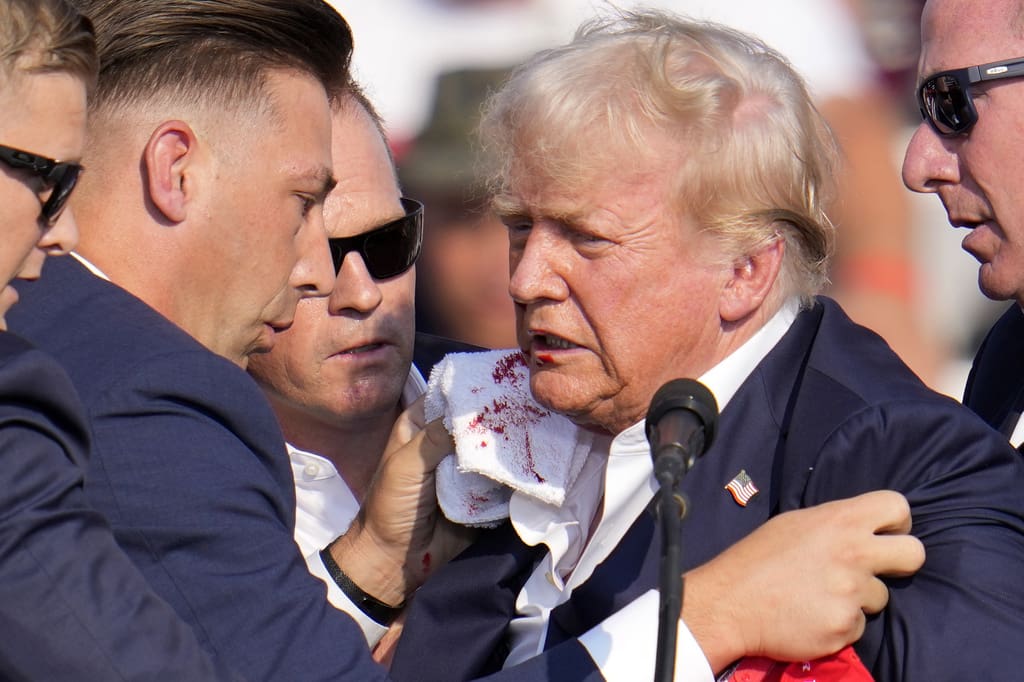 Republican presidential candidate former President Donald Trump is surrounded by U.S. Secret Service at a campaign event in Butler, Pa., on Saturday, July 13, 2024.