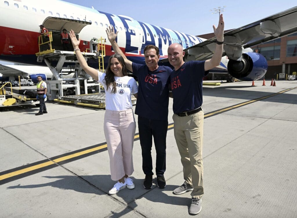 Salt Lake City Mayor Erin Mendenhall, Fraser Bullock and Gov. Spencer Cox, from left, pose for a photo as they depart Utah for Paris.