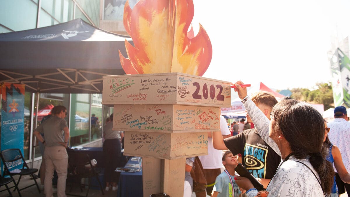 People share memories of the 2002 games on this Olympic torch at the Utah Olympic Park party to celebrate the return of the Games in 2034.