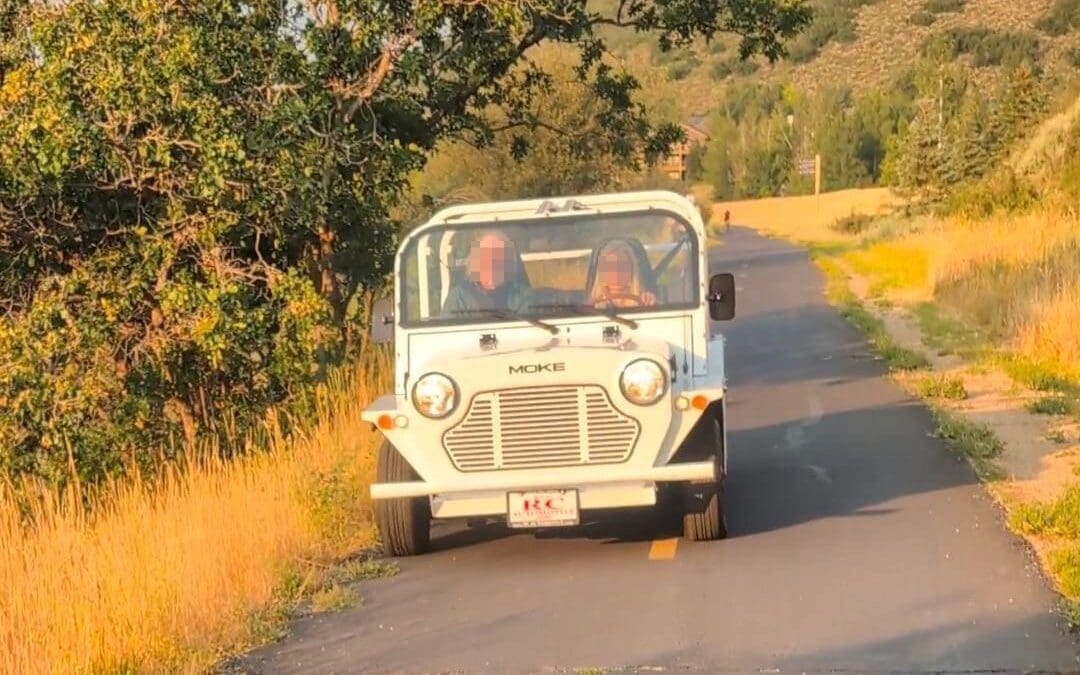 MOKE neighborhood electric vehicle driving on the bike path near Prospector in Park City.