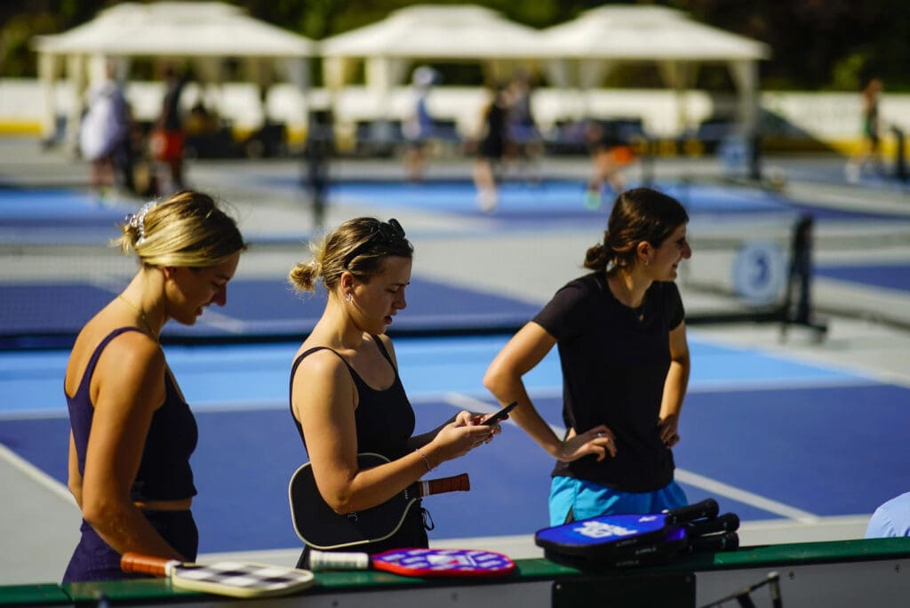 Women wait for friends to practice pickleball on the courts of CityPickle at Central Park’s Wollman Rink, Saturday, Aug. 24, 2024, in New York. 