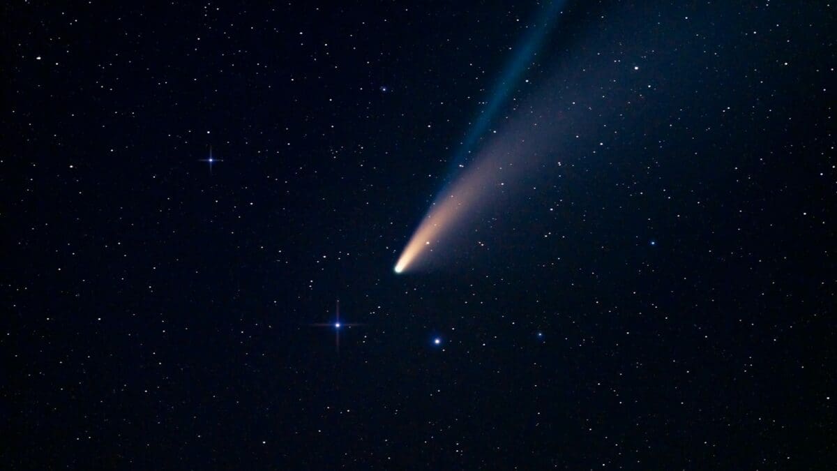 a comet is seen in the night sky