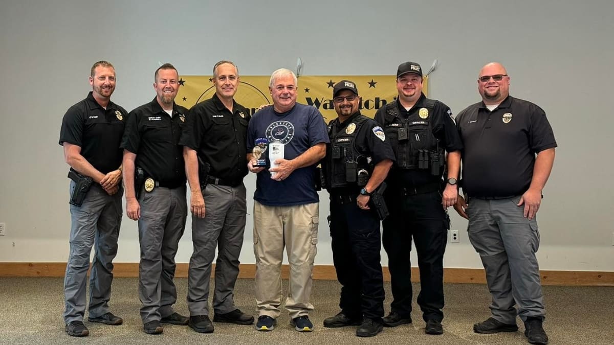 Thomas Greer, center, stands with the Heber City Police Department after receiving the "Busted for Making a Difference" award on Thursday, Aug. 29.