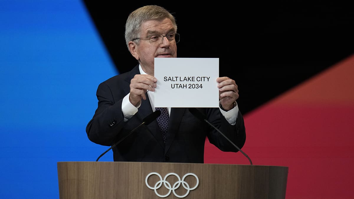 IOC president Thomas Bach holds the board Salt Lake City during the 142nd IOC session at the 2024 Summer Olympics, Wednesday, July 24, 2024, in Paris, France. Salt Lake City was confirmed as host for the 2034 Winter Games by International Olympic Committee.