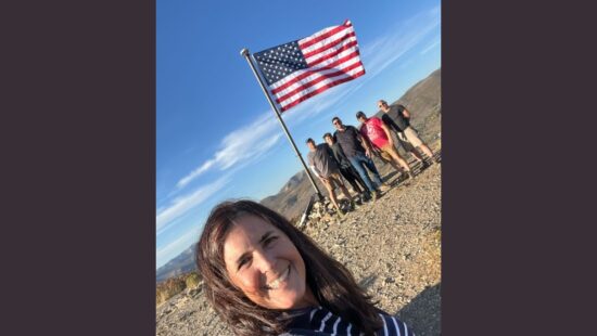 Hladon poses with Mat Young and his son Alex, Ben and his friend Mike after replacing the American flag atop Ecker Hill.