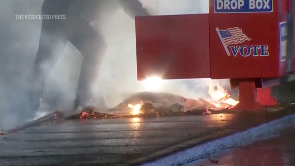 A ballot box on fire in Washington where hundreds of ballots were burned.