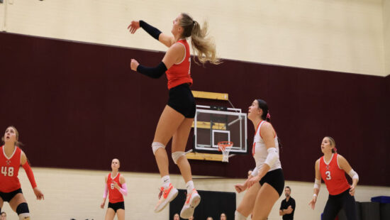 "Sis" Stouffer helps Miners at away, varsity volleyball tournament.