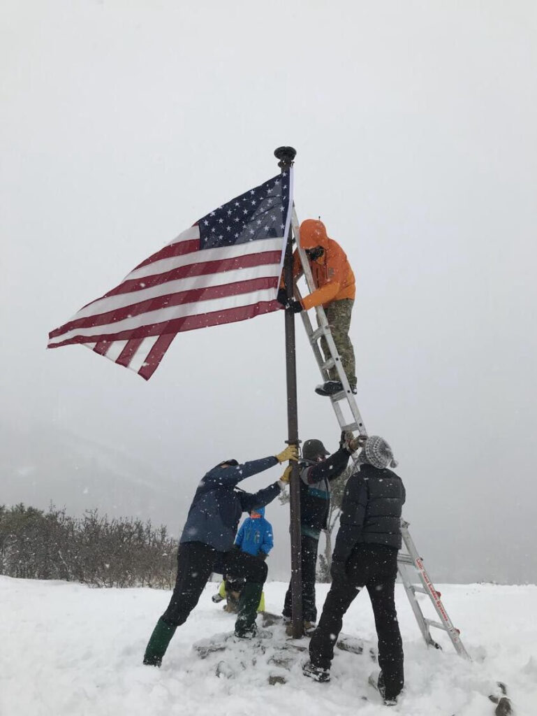 Changing of the flag during a snow storm on Veteran's Day. 