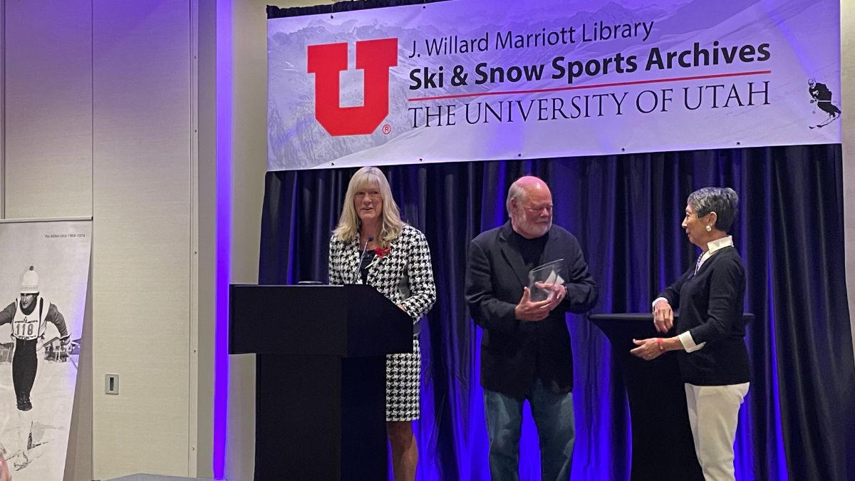 Connie Nelson receiving the S. J. Quinney Award at the 2024 Ski Affair benefit. Nelson shares the stage with David Quinney and Barbara Yamada.