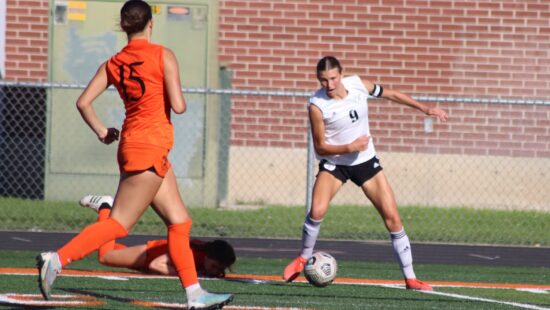 Abby Hanton, in white, will play soccer after graduating as a PCHS Miner.