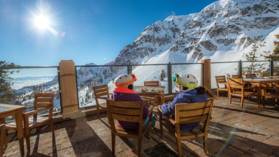 Skiers enjoy lunch on a sunny patio at the top of Snowbasin. (John Paul)