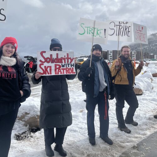 Park City Professional Ski Patrol Association members display signs calling for fair labor practices and a new contract, joined by a furry companion at the picket line near Canyons Resort.