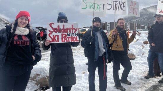 Park City Professional Ski Patrol Association members display signs calling for fair labor practices and a new contract, joined by a furry companion at the picket line near Canyons Resort.