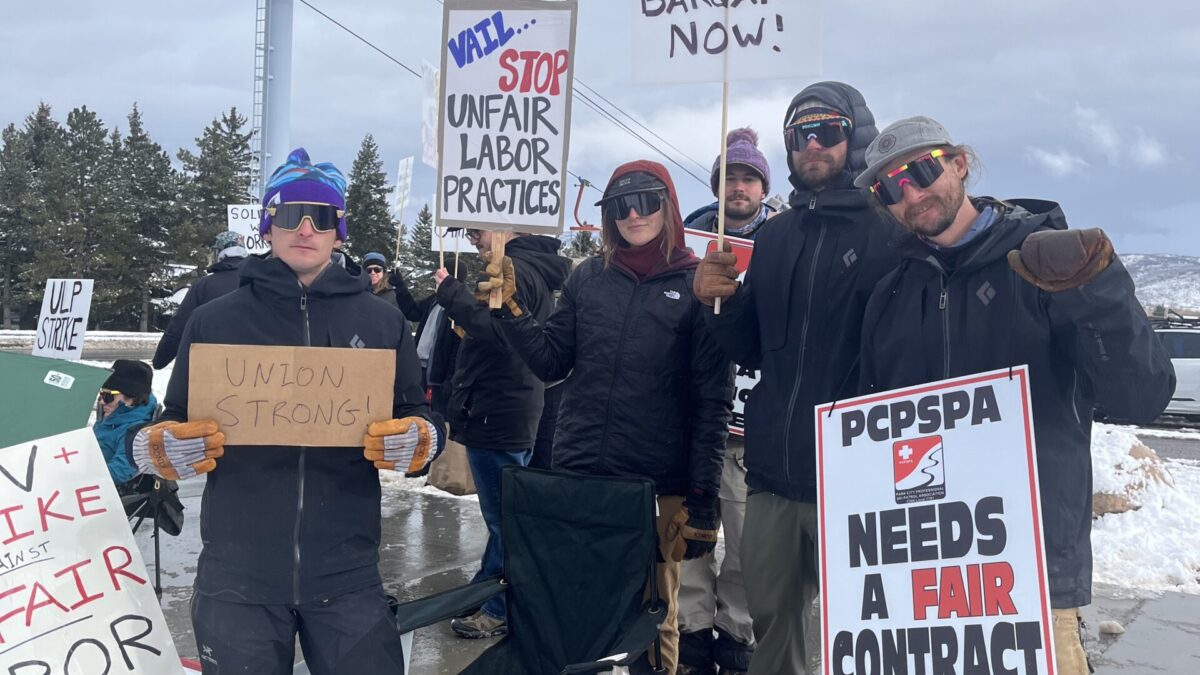 Park City Professional Ski Patrol Association members display signs calling for fair labor practices and a new contract, joined by a furry companion at the picket line near Canyons Resort.