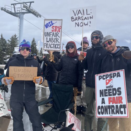 Park City Professional Ski Patrol Association members display signs calling for fair labor practices and a new contract, joined by a furry companion at the picket line near Canyons Resort.