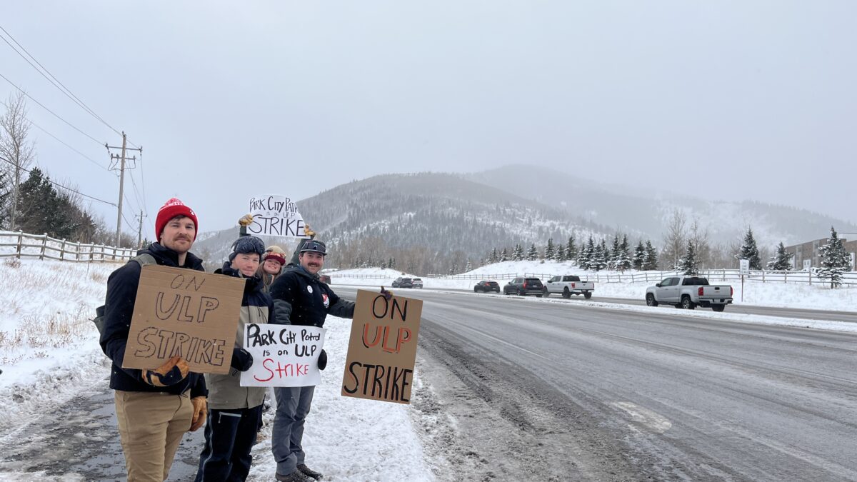 Park City Mountain ski patrollers form a picket line during their strike at Canyons Village, raising awareness of ongoing labor negotiations.