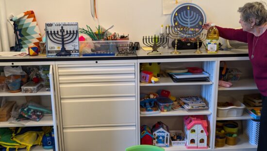 Deb Taylor next to her menorahs before mailing them to flood-ravaged North Carolina.