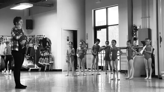 Allison DeBona directing Nutcracker rehearsals with her son Ranger, 7 weeks old at the time.