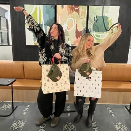 Izzy Pierce (left) and Erin Morris (right) pose with their prizes for the 2024 TownLift Local Holiday Shopping Spree.