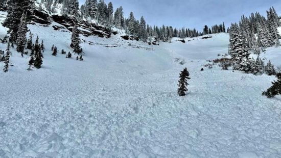 The avalanche debris and snowmobile from an accident in Logan's Steep Hollow that buried and injured one as his brother and father looked on.