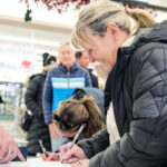 Summit County residents sign the Dakota Pacific referendum at The Market in Park City.