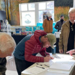 Summit County residents sign the Dakota Pacific referendum at The Market in Park City.