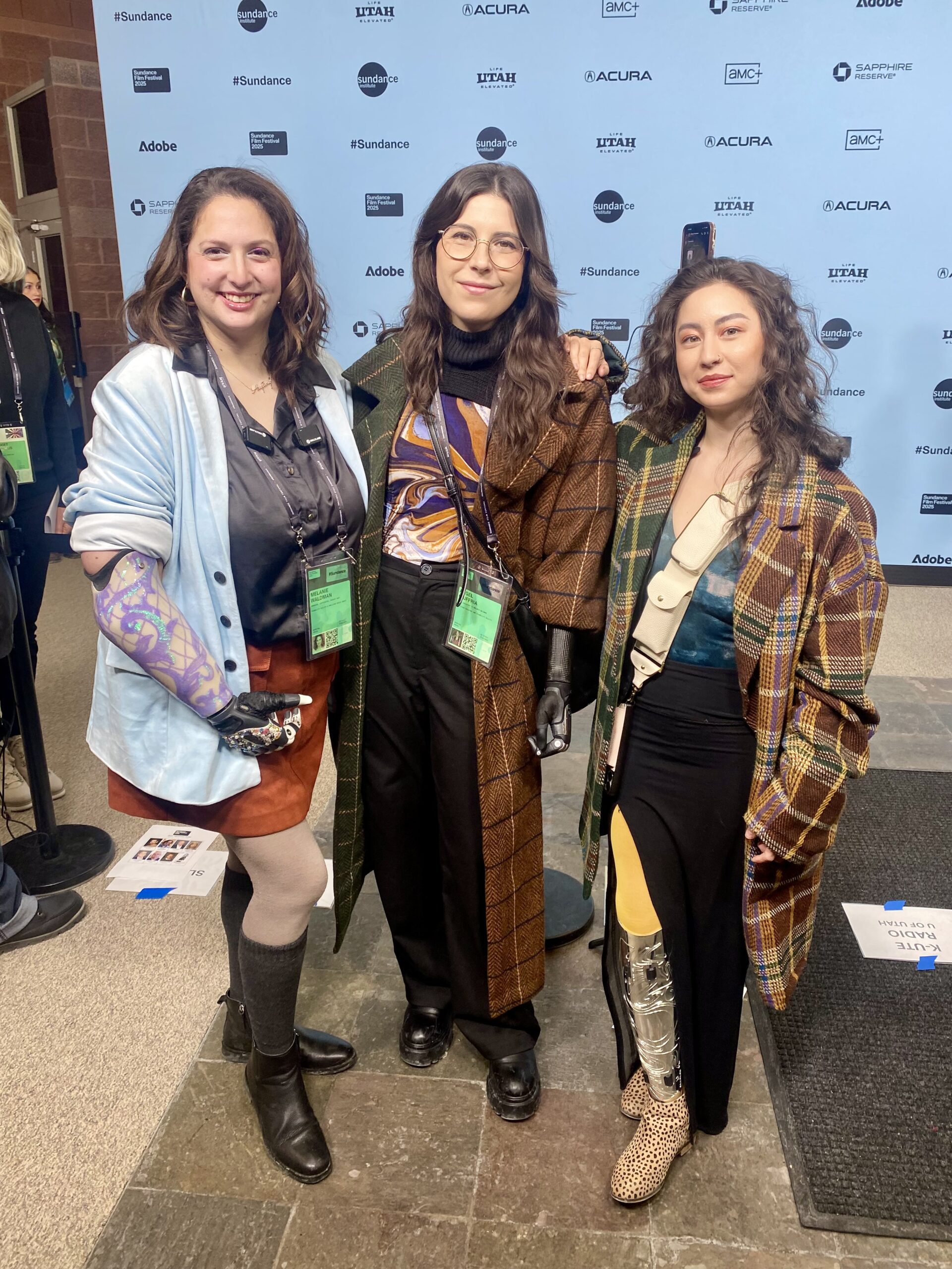 Members of the media for disability attended the red carpet event like this trio of reporters, one with a leg prosthetic and two with arm prosthetics.