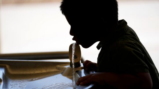 A student drinks from a water fountain at an elementary school in California, Sept. 20, 2023.