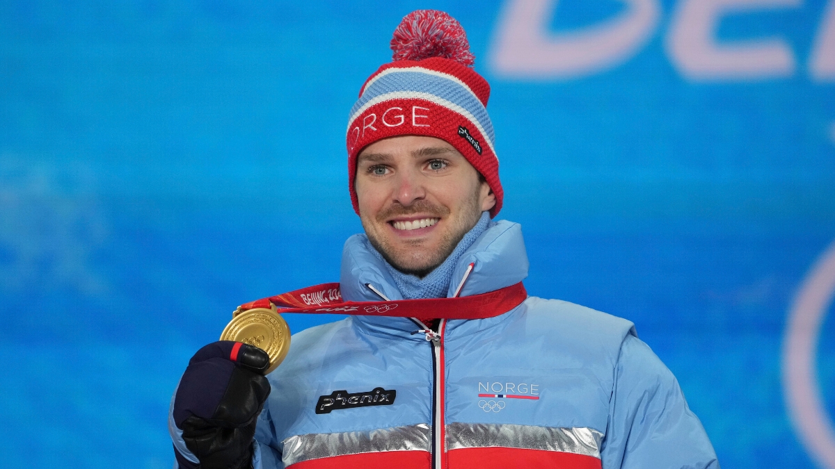 Gold medal winner Norway's Joergen Graabak shows his medal during the nordic combined individual Gunderson large hill/10k medal ceremony at the 2022 Winter Olympics, Wednesday, Feb. 16, 2022, in Zhangjiakou, China.