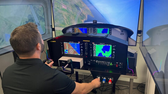 Trip Marshall, aviation instructor at Park City High School, demonstrates the school's flight simulator, which helps students gain hands-on experience with real-world flight maneuvers before entering flight school. The program, supported by the Park City Education Foundation and community funding, prepares students for careers in aviation.