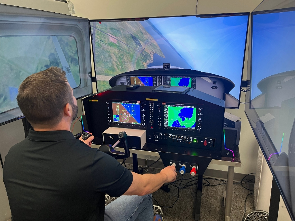 Trip Marshall, aviation instructor at Park City High School, demonstrates the school's flight simulator, which helps students gain hands-on experience with real-world flight maneuvers before entering flight school. The program, supported by the Park City Education Foundation and community funding, prepares students for careers in aviation.