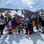 A colorfully clad group of riders convene at OPark City Mountain Resort for a group photo on Feb. 22, 2025. Summit Pride Day