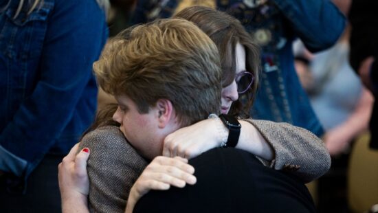 Marcie Robertson, a 20-year-old transgender Utah State University student and resident assistant, hugs her brother Ezra Robertson after speaking at a hearing on HB269, which pertains to privacy protections in sex-designated areas, in the Senate Education standing committee in Salt Lake City on Thursday, Jan. 30, 2025.