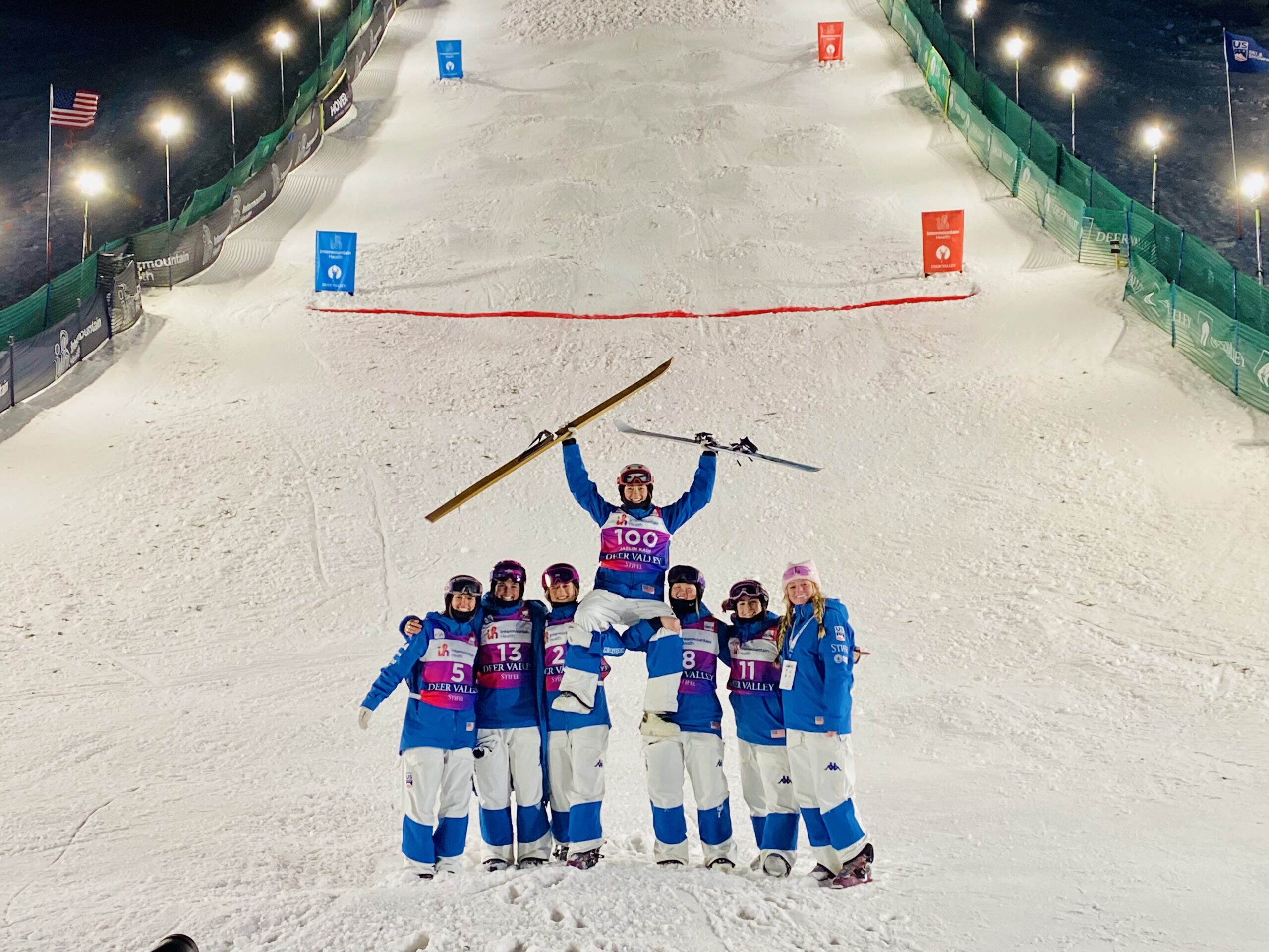 Jaelin Kauf after winning womens moguls being held up by her us ski team moguls women teammates