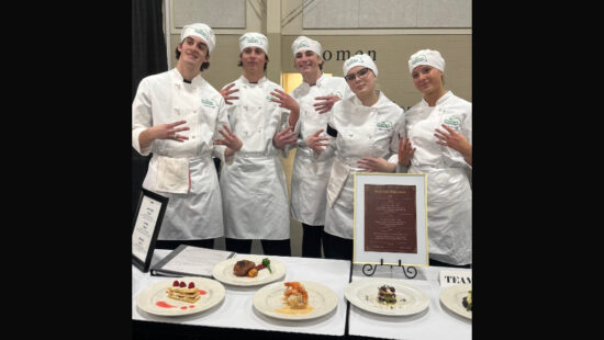 Park City High School ProStart team showcases their culinary creations at the Utah ProStart Culinary State Competition on March 11 at the Mountain America Expo Center in Sandy. The team, led by instructor Kari Patterson, competed using only camp stoves to prepare their dishes, demonstrating skill, precision, and teamwork.