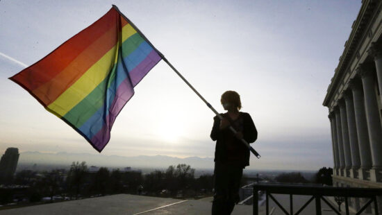 Corbin Aoyagi, a supporter of gay marriage, waves a rainbow flag during a rally at the Utah State Capitol on Jan. 28, 2014, in Salt Lake City.