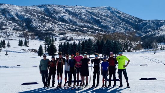 Park City Ski and Snowboard Jr. Nationals Team for Nordic Combined and Ski Jumping. (L-R) Sport Director/Coach Adam Loomis, Seth Rothchild, Luke Miller, Logan Cadman, Liam Demong, Augie Roepke, Rudger Klug, jack McFawn, Donovan Toly, Sadie McCrank, and Olympic Champion/Coach Billy Demong.