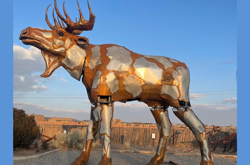 A 23-foot-tall steel moose sculpture by artists Don Kennell and Lisa Adler stands temporarily outside their Santa Fe studio. The monumental piece will be installed in the Jeremy Ranch roundabout this June as part of the public art project Neighbors, celebrating Summit County’s connection to wildlife and place.
