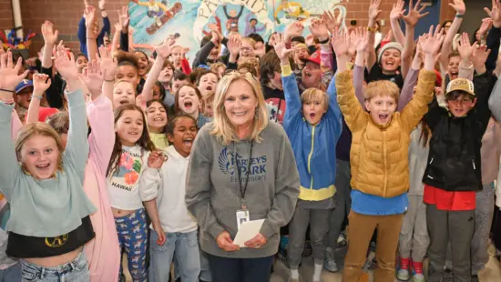 Leann Rocchi, surrounded by cheering students at Parley’s Park Elementary, is surprised with a 2024 Excellent Educator Award during a celebratory visit led by the Park City Education Foundation.
