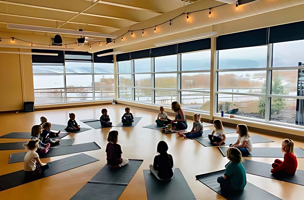 Students gather with Randi Jo Greenberg in a circle for a mindfulness session led by Mindful. Summit County, creating space for stillness, breath, and emotional awareness in a peaceful, light-filled room overlooking Swaner.